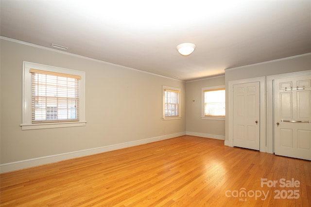 interior space with ornamental molding and light wood-type flooring