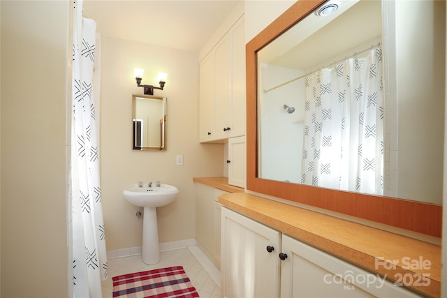 bathroom with tile patterned floors and a shower with shower curtain