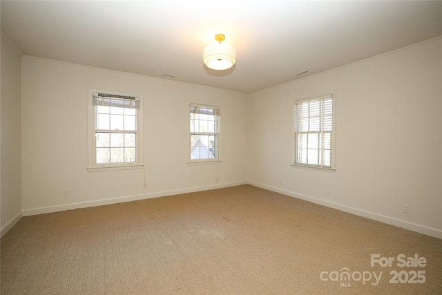 carpeted spare room with a wealth of natural light