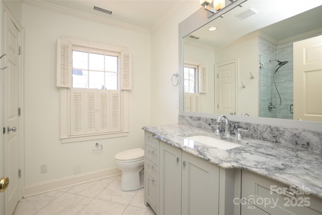 bathroom with vanity, crown molding, toilet, and tiled shower