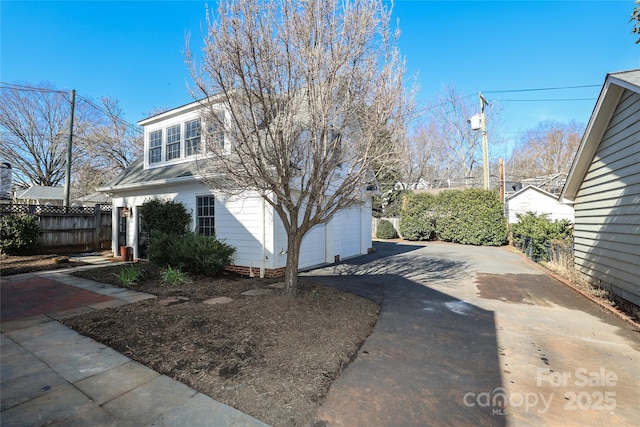 view of front of property featuring a garage and an outdoor structure