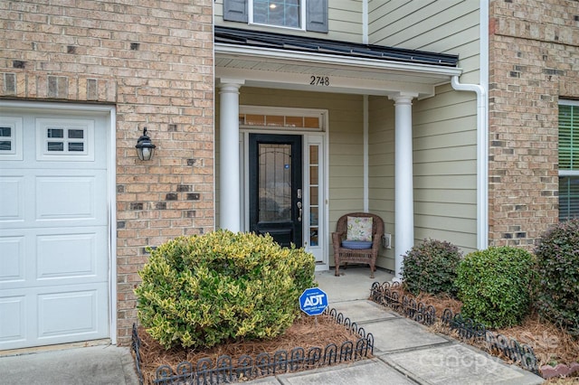 view of exterior entry featuring a garage