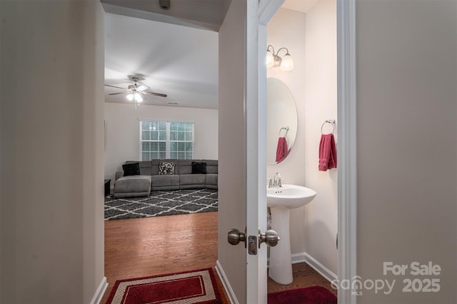 bathroom featuring hardwood / wood-style flooring and ceiling fan