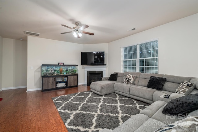 living room featuring dark hardwood / wood-style flooring and ceiling fan