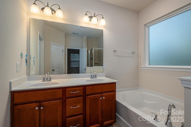 bathroom featuring vanity and shower with separate bathtub