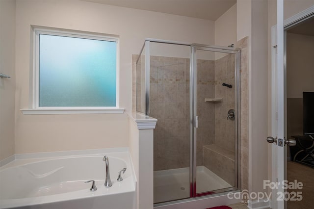 bathroom featuring separate shower and tub