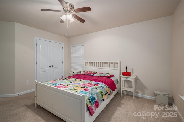 bedroom with light carpet, a closet, and ceiling fan