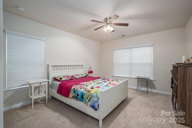 bedroom featuring light colored carpet and ceiling fan