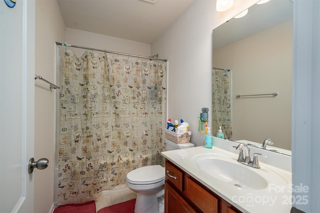 bathroom featuring vanity, tile patterned flooring, and toilet