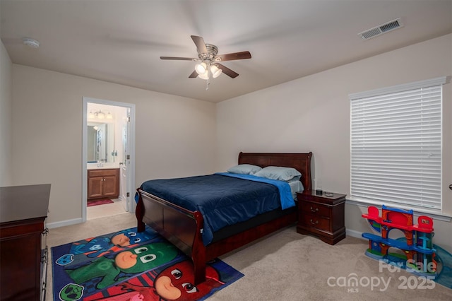 carpeted bedroom featuring ceiling fan and ensuite bathroom