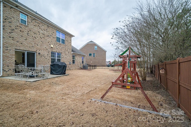 view of yard featuring a playground and a patio area