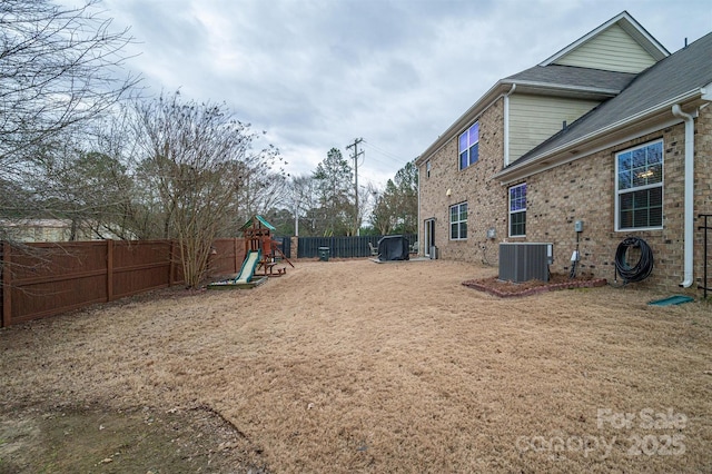 view of yard with central AC unit and a playground