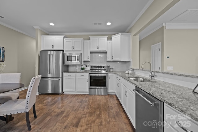 kitchen featuring light stone counters, appliances with stainless steel finishes, sink, and white cabinets