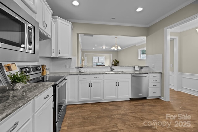 kitchen featuring white cabinetry, sink, crown molding, and stainless steel appliances