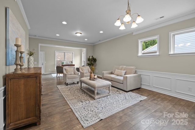 living room featuring crown molding, a healthy amount of sunlight, and dark hardwood / wood-style flooring