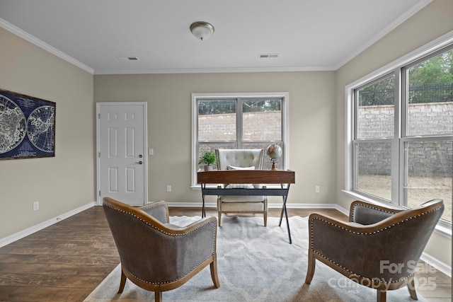 sitting room with hardwood / wood-style flooring, ornamental molding, and a healthy amount of sunlight