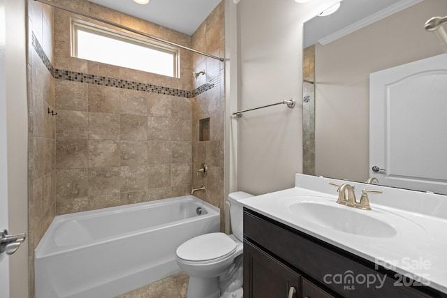 full bathroom featuring tiled shower / bath, vanity, and toilet