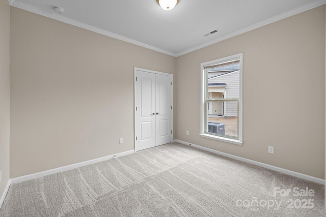 carpeted empty room with ornamental molding