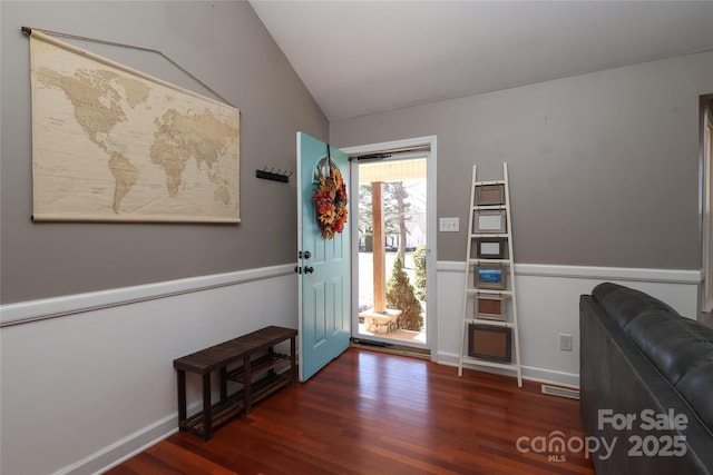 entrance foyer featuring dark hardwood / wood-style flooring and vaulted ceiling