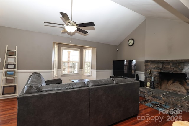 living room featuring lofted ceiling, a fireplace, dark hardwood / wood-style floors, and ceiling fan