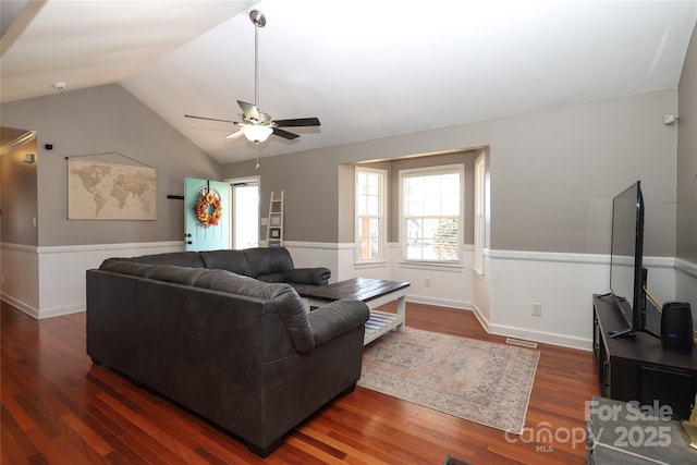 living room featuring ceiling fan, lofted ceiling, and dark hardwood / wood-style flooring