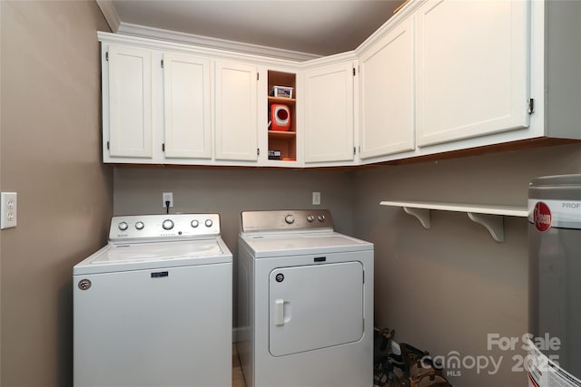 washroom featuring cabinets and washing machine and clothes dryer