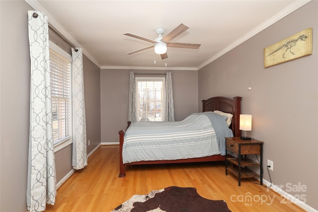 bedroom with ornamental molding, ceiling fan, and light hardwood / wood-style flooring