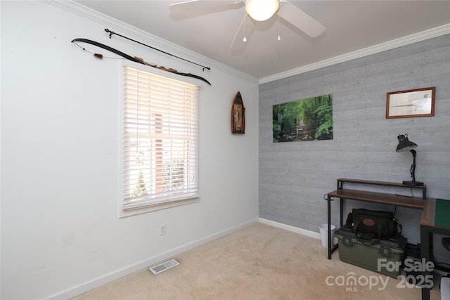 interior space with ornamental molding, light carpet, and ceiling fan