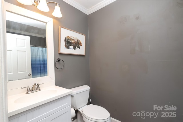 bathroom featuring vanity, crown molding, and toilet