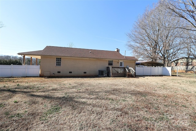 rear view of house with central AC, a lawn, a carport, and a deck