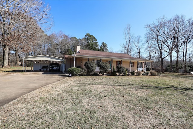 ranch-style house with a carport, covered porch, and a front yard