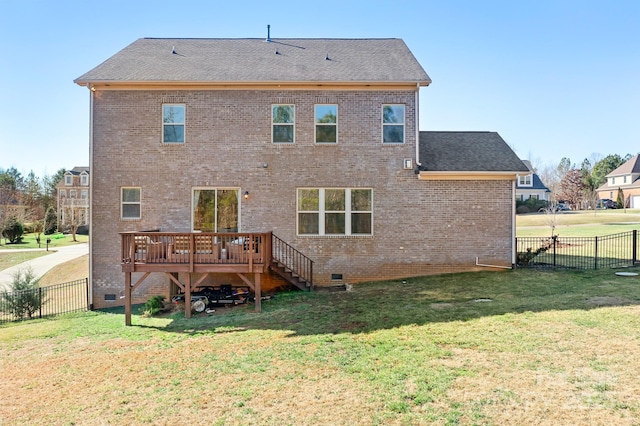 rear view of house featuring a deck and a lawn