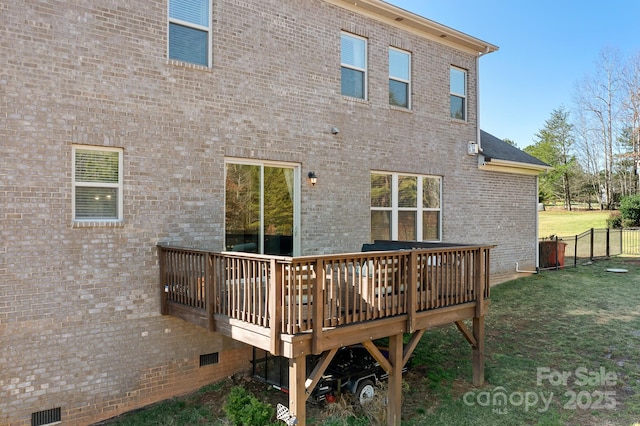 rear view of house featuring a yard and a deck