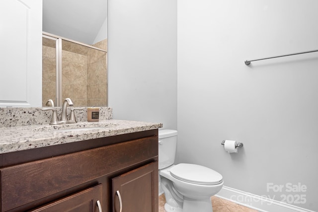 bathroom with vanity, tile patterned floors, toilet, and walk in shower