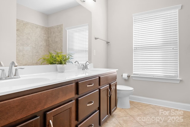 bathroom featuring vanity, tile patterned floors, and toilet