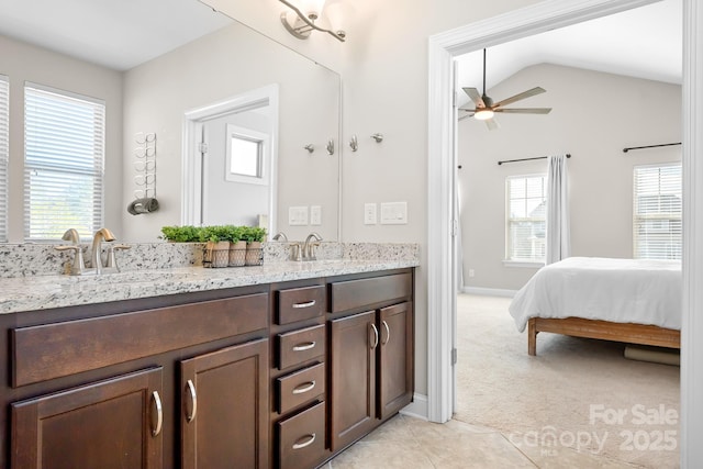 bathroom with tile patterned flooring, vanity, lofted ceiling, and ceiling fan