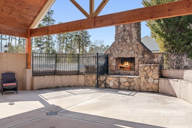 view of patio with an outdoor stone fireplace