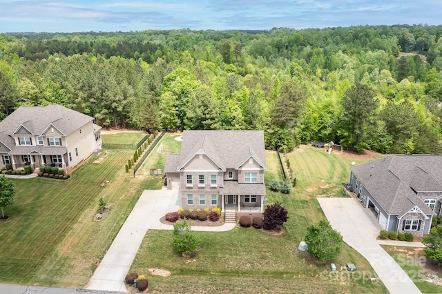 birds eye view of property with a view of trees