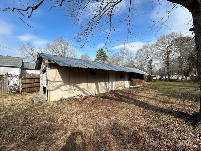 view of side of home with a lawn