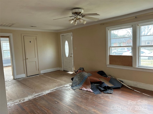 entrance foyer featuring crown molding and ceiling fan