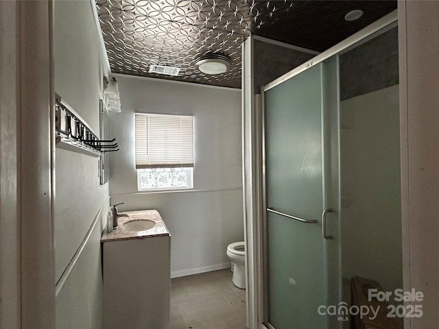 bathroom with an enclosed shower, vanity, and toilet