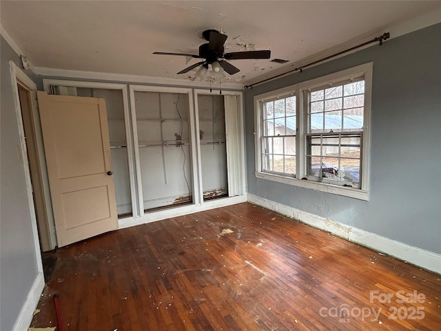 unfurnished bedroom with dark wood-type flooring and ceiling fan