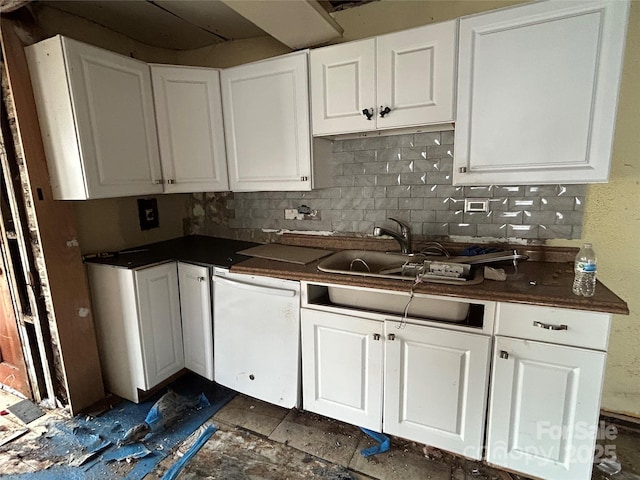 kitchen featuring tasteful backsplash, white dishwasher, sink, and white cabinets