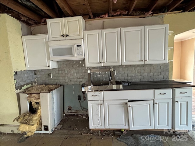 kitchen featuring white cabinetry and decorative backsplash