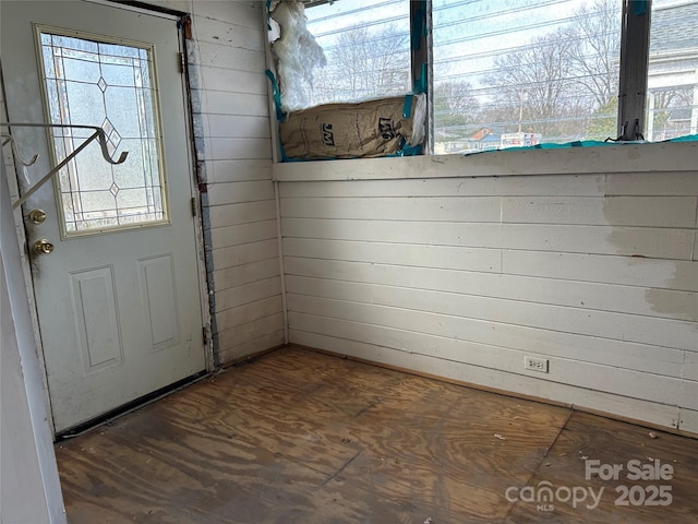 interior space featuring wood walls