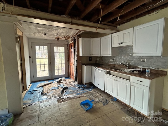 kitchen featuring french doors, backsplash, dishwasher, and white cabinets