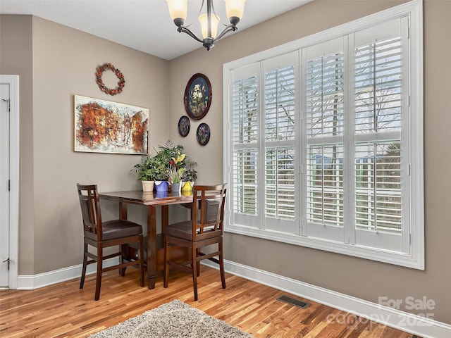 dining room featuring a chandelier and light hardwood / wood-style floors