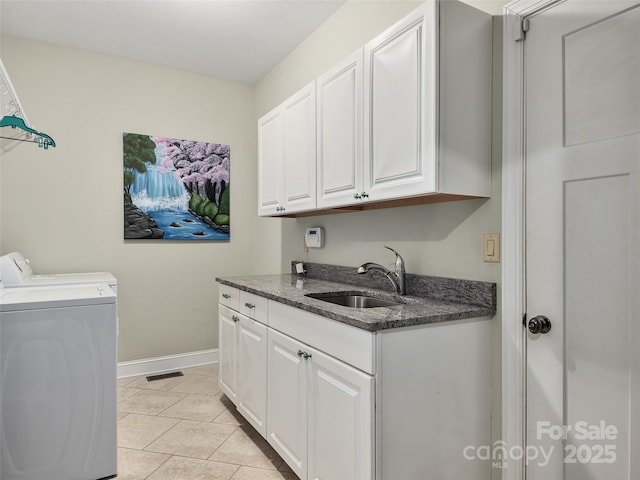 laundry room with sink, light tile patterned floors, cabinets, and washing machine and clothes dryer