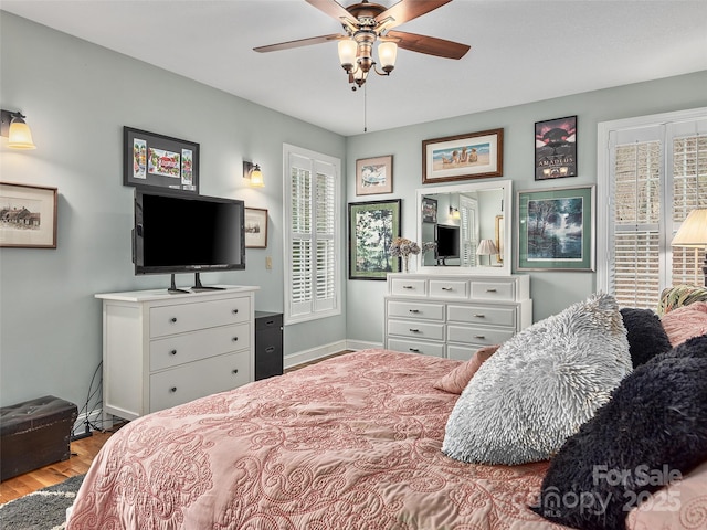 bedroom with ceiling fan and light wood-type flooring