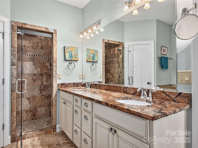 bathroom with vanity and a shower with door